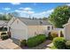 View of home with a white privacy fence, attached garage and neatly trimmed shrubbery at 1228 W Oaks Way, Woodstock, GA 30188