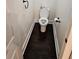 Compact powder room with dark hardwood floors and a white toilet at 3268 Mae Ave, Brookhaven, GA 30319
