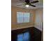 Bedroom with dark hardwood floors, a modern ceiling fan, and a large window at 3268 Mae Ave, Brookhaven, GA 30319
