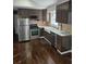 Well-lit kitchen featuring stainless steel appliances, dark wood cabinets, and a farmhouse sink at 3268 Mae Ave, Brookhaven, GA 30319