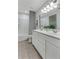 A clean and modern bathroom with double vanity, tiled floors, and a shower-tub combination at 6102 Marigold Way, Atlanta, GA 30349