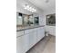 A well-lit bathroom featuring double sinks, granite countertops, and modern fixtures at 6102 Marigold Way, Atlanta, GA 30349