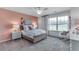 A bright and airy bedroom with a large window, soft pastel accents, and cozy decor at 6102 Marigold Way, Atlanta, GA 30349