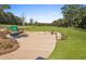 Community fire pit area with a beautiful lawn and wooded background for outdoor enjoyment at 6102 Marigold Way, Atlanta, GA 30349