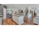 Spacious kitchen featuring an island with seating, stainless steel appliances, and hardwood flooring throughout at 6102 Marigold Way, Atlanta, GA 30349