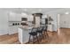 Bright kitchen with granite countertops, a center island with seating, and stainless steel appliances at 6102 Marigold Way, Atlanta, GA 30349