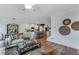 Open-concept living area with hardwood floors, comfortable seating, and seamless access to the modern kitchen at 6102 Marigold Way, Atlanta, GA 30349