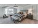 A serene main bedroom with a large window, stylish furniture, and elegant decor at 6102 Marigold Way, Atlanta, GA 30349