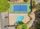 Aerial view of the community pool and tennis court with parking and greenery at 1401 Parkaire Xing, Marietta, GA 30068