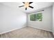 Sunlit bedroom boasts a window view, ceiling fan and neutral carpeting at 1401 Parkaire Xing, Marietta, GA 30068