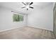 Bedroom features a window view, ceiling fan and neutral carpeting at 1401 Parkaire Xing, Marietta, GA 30068