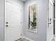 Bright entryway with white door, transom window and light gray walls and gray wood-look floors at 1401 Parkaire Xing, Marietta, GA 30068