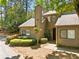 Charming townhouse with neutral siding, mature landscaping and inviting front entrance at 1401 Parkaire Xing, Marietta, GA 30068