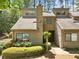 Charming townhouse with neutral siding, mature landscaping and inviting front entrance at 1401 Parkaire Xing, Marietta, GA 30068