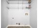 Empty laundry room features wire shelving and plumbing access for washer and dryer hookups at 1401 Parkaire Xing, Marietta, GA 30068