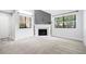 Cozy living room features neutral carpet, fireplace with white mantle and bright windows at 1401 Parkaire Xing, Marietta, GA 30068