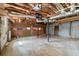 Unfinished basement with exposed ceiling, cement floors, brick walls, and garage doors at 230 Oakridge Se Dr, Cartersville, GA 30121