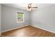 A sunlit bedroom featuring hardwood floors, a ceiling fan, and a window with natural light at 230 Oakridge Se Dr, Cartersville, GA 30121