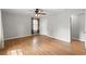 A bedroom with hardwood floors, ceiling fan, window, closet, and view of another room at 230 Oakridge Se Dr, Cartersville, GA 30121