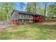 Split-level home boasts a two-car garage and a covered red front porch at 230 Oakridge Se Dr, Cartersville, GA 30121