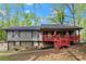Two-story house features a stone foundation and welcoming red front porch at 230 Oakridge Se Dr, Cartersville, GA 30121