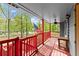 Covered porch showcasing a ceiling fan, wooden bench, and views of the neighborhood at 230 Oakridge Se Dr, Cartersville, GA 30121