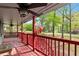 Covered front porch featuring a ceiling fan, wooden bench and an American flag at 230 Oakridge Se Dr, Cartersville, GA 30121