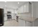 Modern kitchen boasts stainless steel appliances, white cabinets and a breakfast bar at 230 Oakridge Se Dr, Cartersville, GA 30121