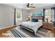 Staged main bedroom boasts a ceiling fan, hardwood floors, and natural light at 230 Oakridge Se Dr, Cartersville, GA 30121