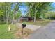 Cozy house with a driveway and a charming mailbox on a tree-lined street at 230 Oakridge Se Dr, Cartersville, GA 30121
