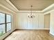 Bright dining room featuring hardwood floors, crown molding, wainscoting, and elegant light fixture at 237 Lotus Ln, Covington, GA 30016