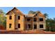 Two-story new construction home featuring a classic architectural design with wood frames and unfinished exterior, set on a spacious lot at 237 Lotus Ln, Covington, GA 30016