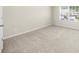 Bright bedroom with a large window, neutral carpet, and view of the neighborhood at 1439 Brookmere Way, Cumming, GA 30040
