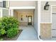 Close up of the front door, showcasing the brick facade, front light and well-maintained landscaping at 1439 Brookmere Way, Cumming, GA 30040
