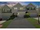Inviting townhouse exterior with driveway, attached garage, and well-maintained lawn, complete with colorful landscaping at 1439 Brookmere Way, Cumming, GA 30040