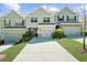 Inviting townhouse exterior with driveway, attached garage, and well-maintained lawn, complete with colorful landscaping at 1439 Brookmere Way, Cumming, GA 30040