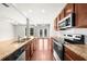 Well-equipped kitchen with stainless steel appliances, granite countertops, and a breakfast bar at 1439 Brookmere Way, Cumming, GA 30040