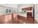 Open-concept living room with hardwood floors, flowing seamlessly into the modern kitchen at 1439 Brookmere Way, Cumming, GA 30040