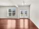 Bright living room featuring hardwood floors, a window, and glass doors to outdoor space at 1439 Brookmere Way, Cumming, GA 30040