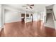 Spacious living room with hardwood floors leading to an open kitchen and staircase at 1439 Brookmere Way, Cumming, GA 30040
