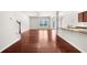 Open-concept living room with hardwood floors, flowing seamlessly into the kitchen at 1439 Brookmere Way, Cumming, GA 30040