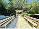 Outdoor deck featuring an area to grill, long benches, and wooden floors at 1501 Clairmont Rd # 1818, Decatur, GA 30033