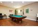 Game room with a pool table, cues, and comfortable seating for leisure and entertainment at 1501 Clairmont Rd # 1818, Decatur, GA 30033