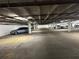 Spacious parking garage with cars parked in designated spots and visible lighting fixtures at 1501 Clairmont Rd # 1818, Decatur, GA 30033