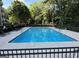 Community pool surrounded by lounging chairs and lush greenery for relaxation and enjoyment at 1501 Clairmont Rd # 1818, Decatur, GA 30033