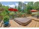Outdoor deck featuring a hot tub, seating, and an umbrella, perfect for relaxation and enjoying the backyard scenery at 1760 Commonwealth Trl, Cumming, GA 30041