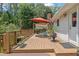 Outdoor deck featuring a seating area, potted plants, and a tranquil view, perfect for relaxation and enjoying the outdoors at 1760 Commonwealth Trl, Cumming, GA 30041