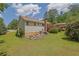 A view of the home's backyard featuring a patio and lush greenery at 1760 Commonwealth Trl, Cumming, GA 30041