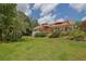 Spacious backyard featuring lush greenery, a deck with outdoor furniture, and mature trees, perfect for outdoor enjoyment at 1760 Commonwealth Trl, Cumming, GA 30041