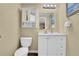 Bathroom with a white vanity, mirrored cabinet, and toilet, designed for functionality and comfort at 1760 Commonwealth Trl, Cumming, GA 30041